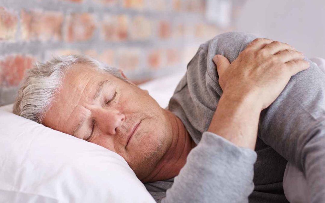 Shot of a senior man sleeping in bed, grabbing at his shoulder. Sleeping with shoulder pain tips