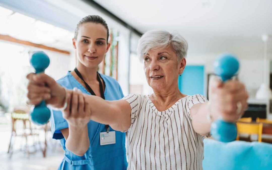 Physical therapist with a patient doing physiotherapy with dumbbell